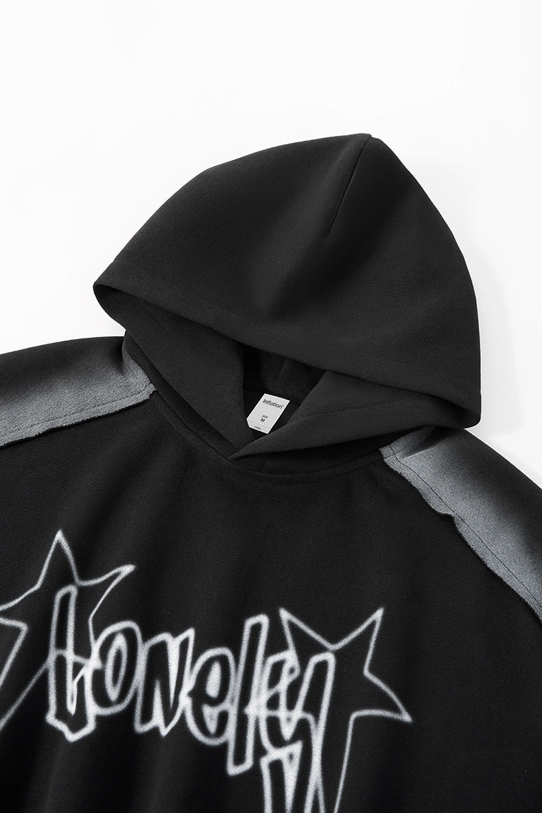 Hood detail close-up on black graphic hoodie, clean neckline.