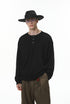 Man wearing a black hat, black long-sleeve henley t shirt, and brown pants on a white background