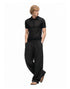 Black relaxed drawstring pants styled with a black knit polo and sandals.