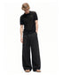 Full-length front view of men's black wide-leg pants with side pockets.