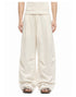 Ivory drawstring wide-leg pants showing mid-rise waist and softly curved legs.