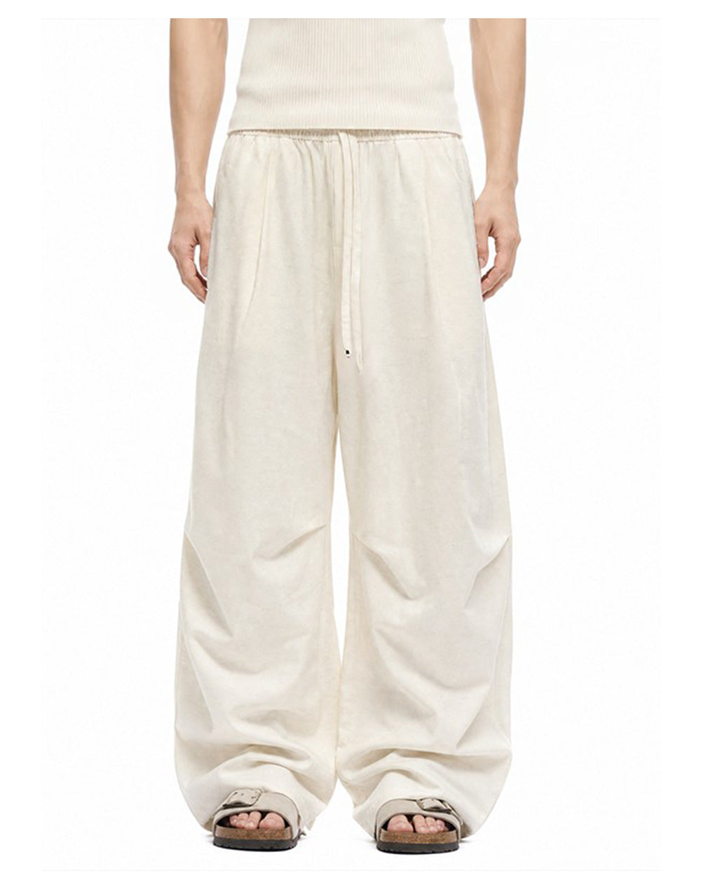 Ivory drawstring wide-leg pants showing mid-rise waist and softly curved legs.