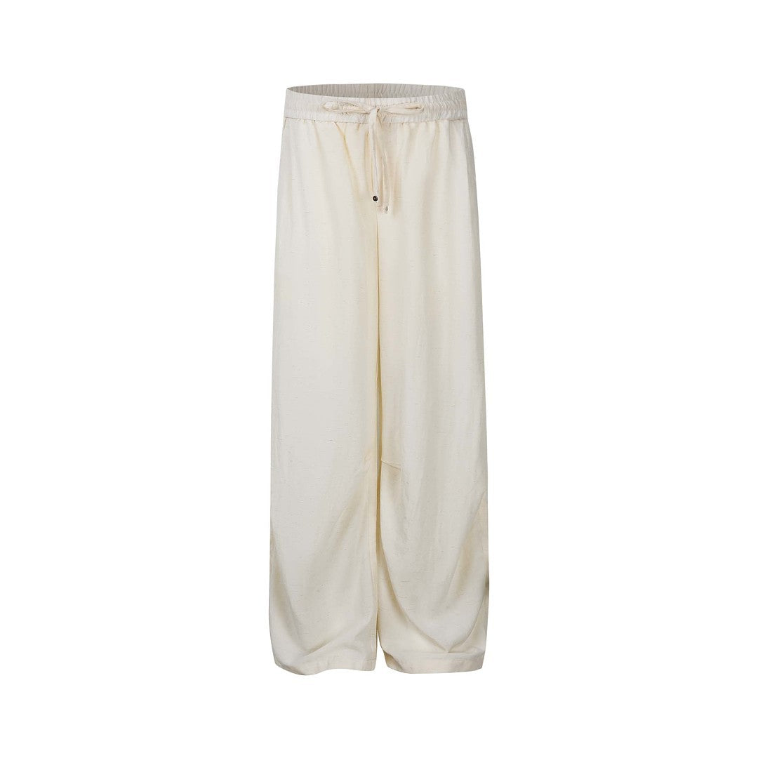 Ivory men's relaxed drawstring wide-leg pants isolated on white.