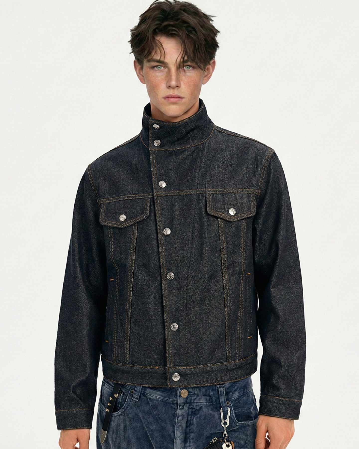 Men's stand collar dark indigo denim jacket shown buttoned in a front close-up