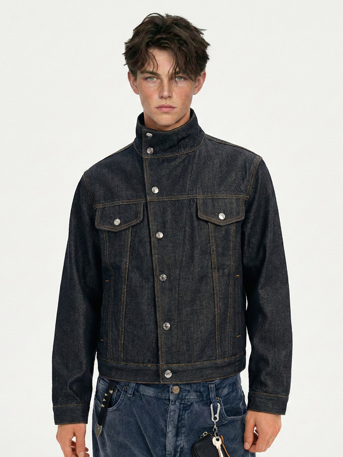 Men's stand collar dark indigo denim jacket shown buttoned in a front close-up