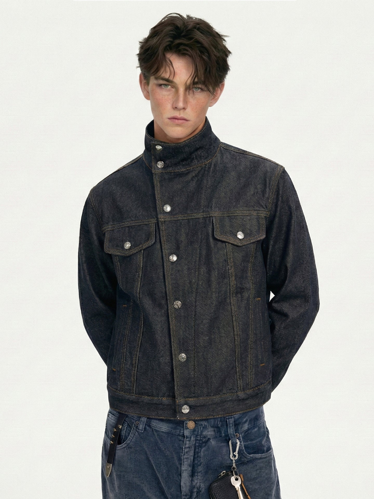 Three-quarter front close-up showing high collar, flap chest pockets, and snap button placket
