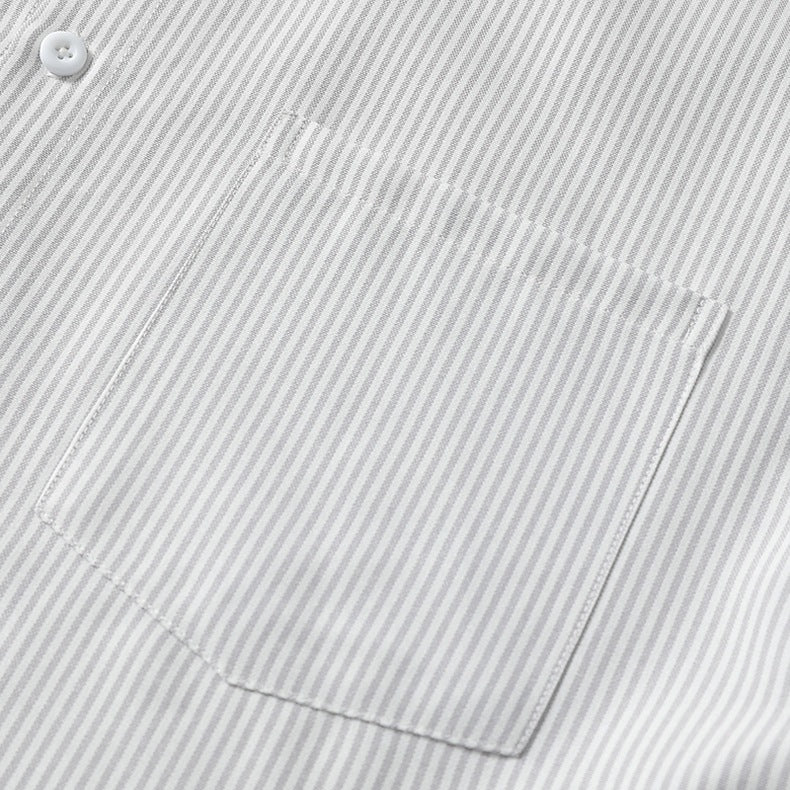 Detailed close-up shot of the long sleeve button cuff on grey vertical pinstripe shirt material.