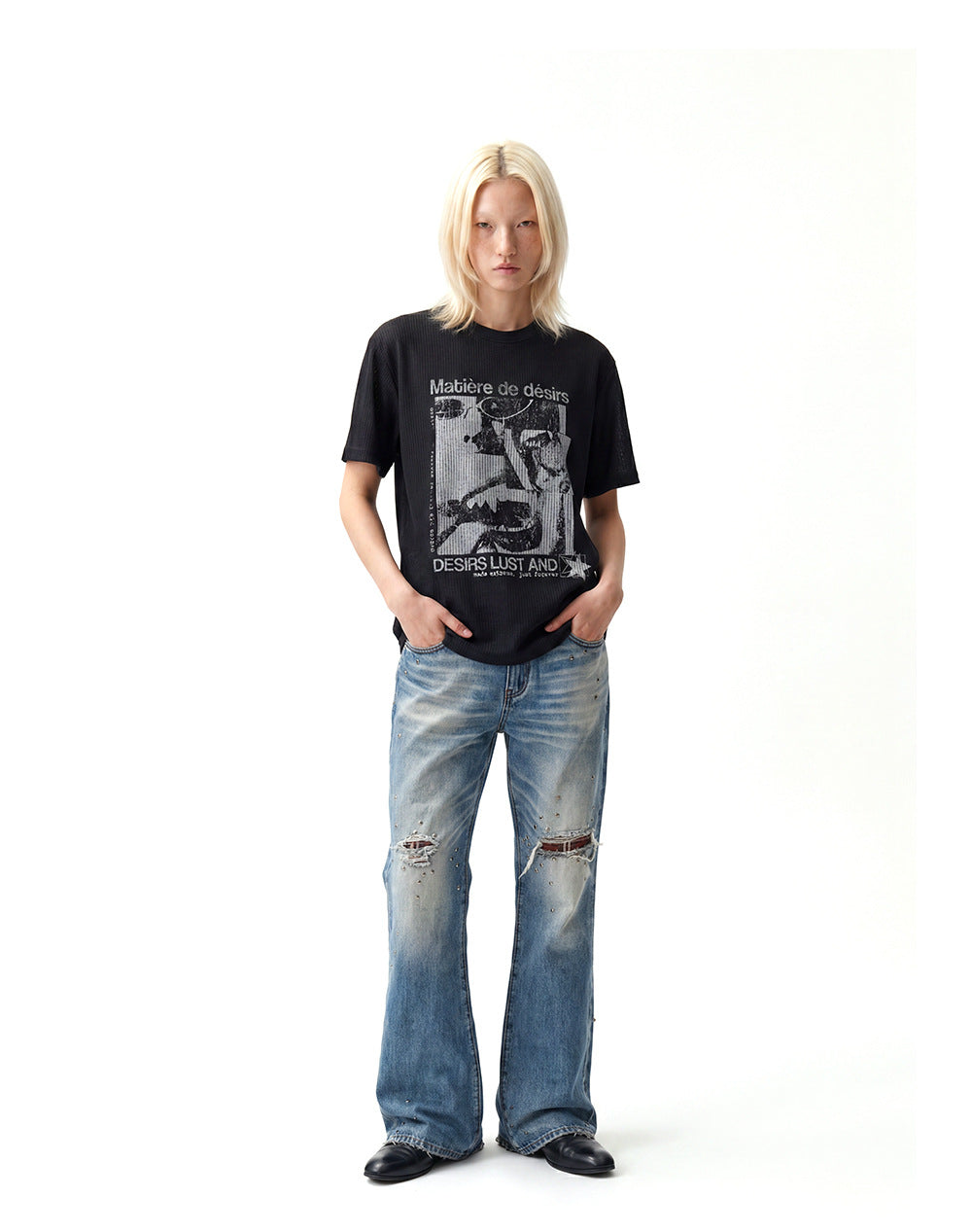 Men's vintage-style punk graphic T-shirt in black styled with distressed wide-leg jeans.