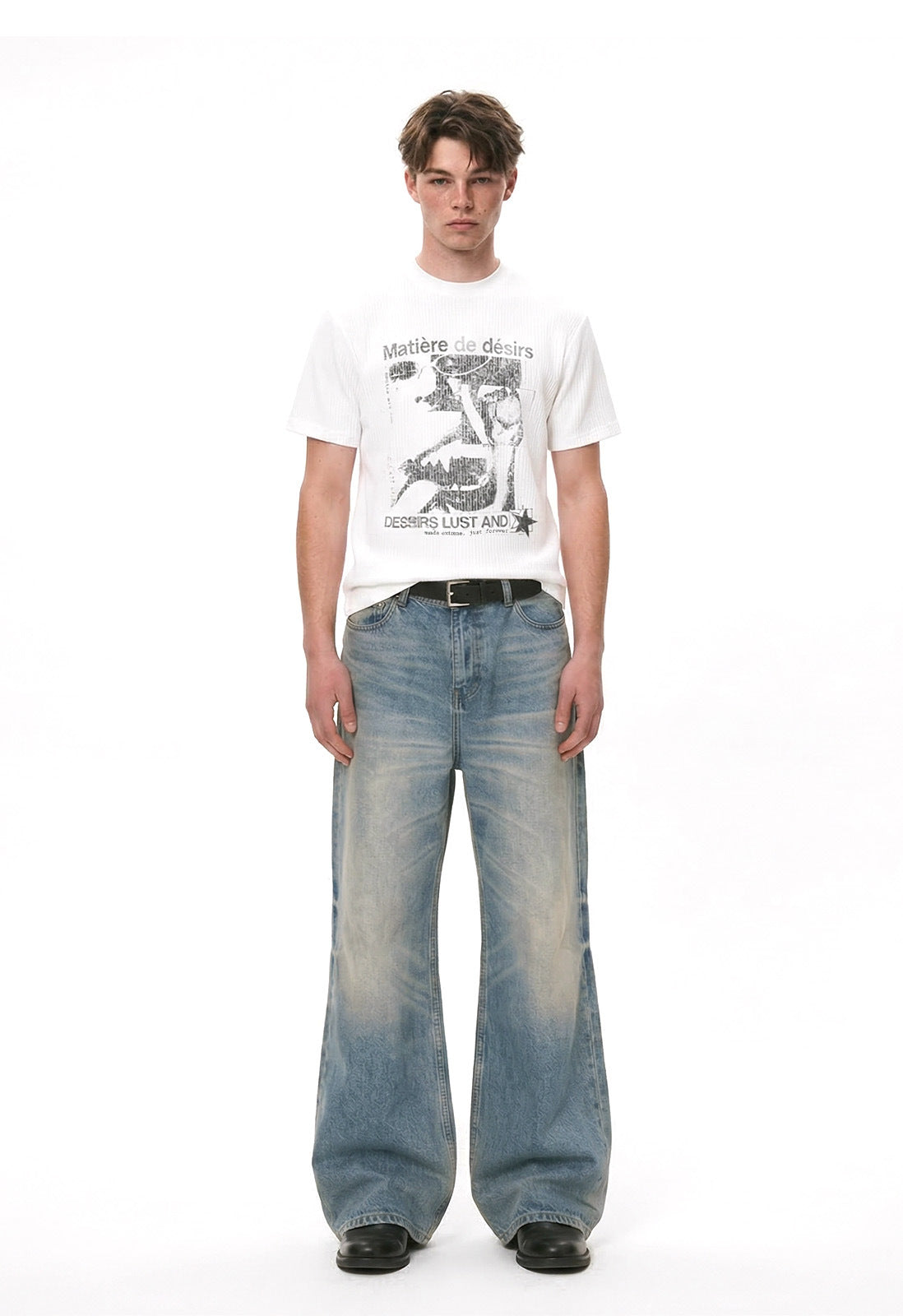 White graphic T-shirt styled with faded wide-leg jeans in a full-length front view.