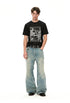Full-length styling view of black graphic tee with wide blue jeans.