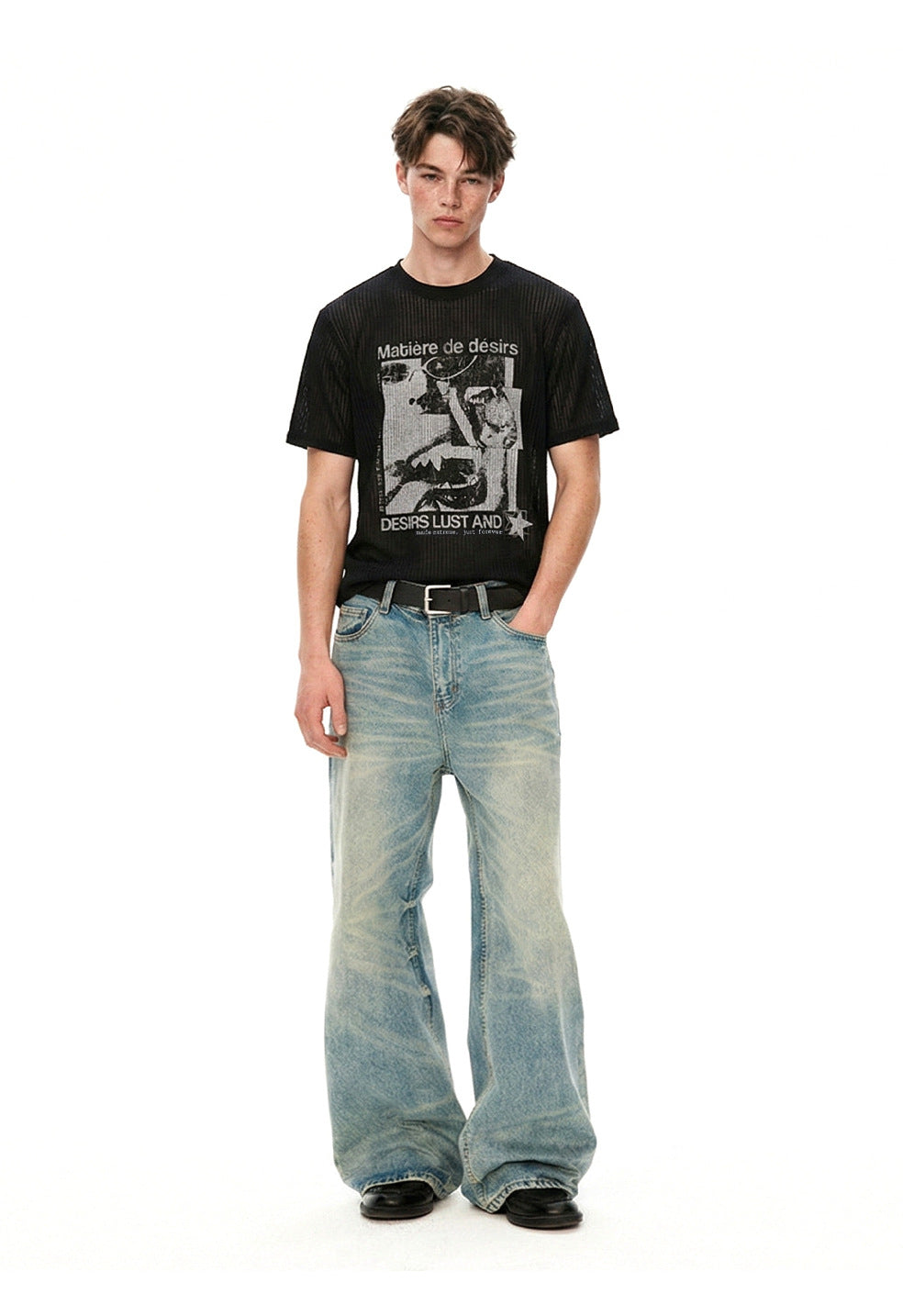Full-length styling view of black graphic tee with wide blue jeans.