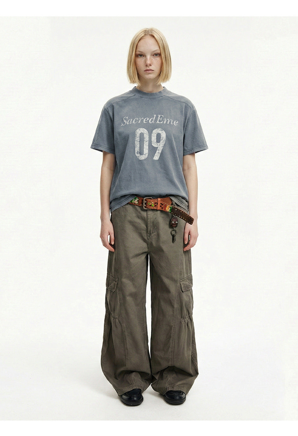 Men's vintage washed graphic T-shirt in blue gray styled with wide-leg cargo pants.