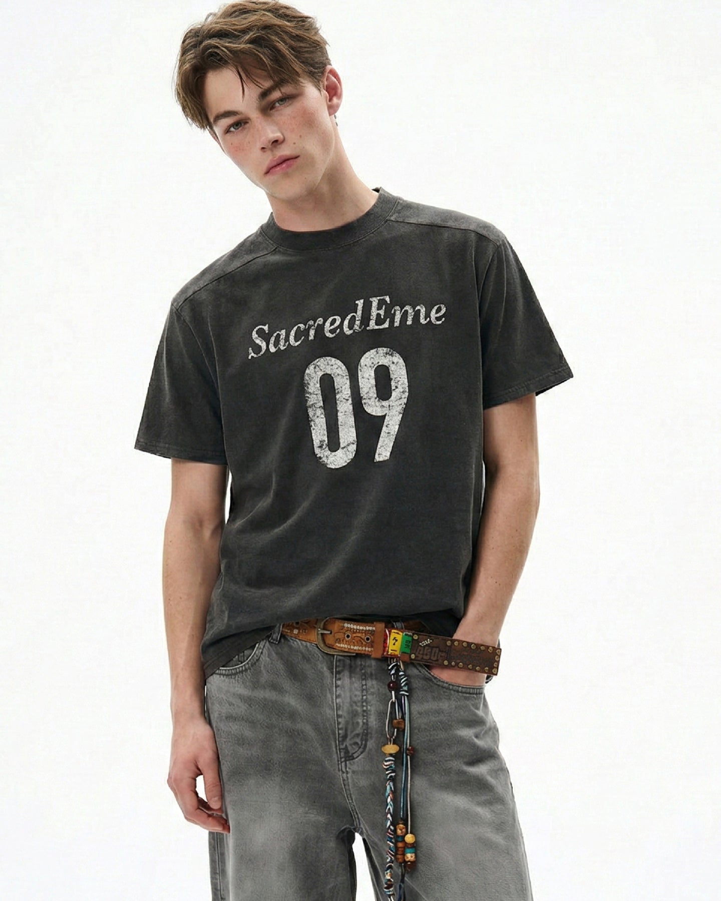 Washed black boxy graphic tee with distressed 09 print and gray denim.