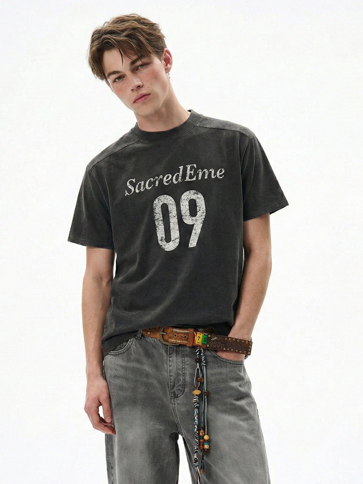Washed black boxy graphic tee with distressed 09 print and gray denim.