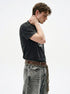 Side view of washed black boxy T-shirt showing straight shoulders and short sleeves.