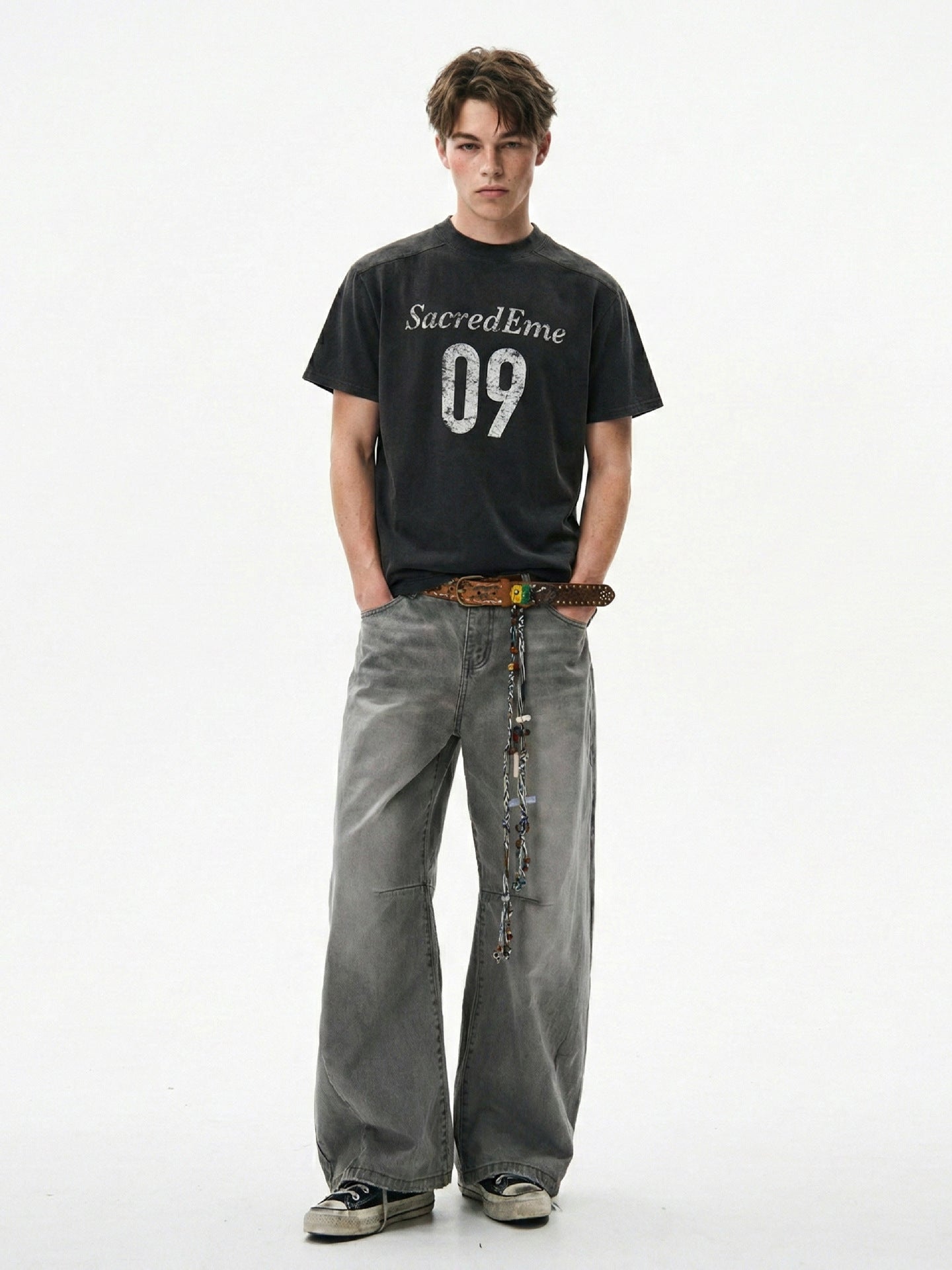 Full-length styling view of washed black 09 graphic tee with wide gray jeans.