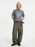 Blue-gray washed graphic T-shirt paired with wide-leg olive cargo pants.
