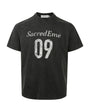 Blue-gray crewneck graphic T-shirt isolated on white with faded varsity design.