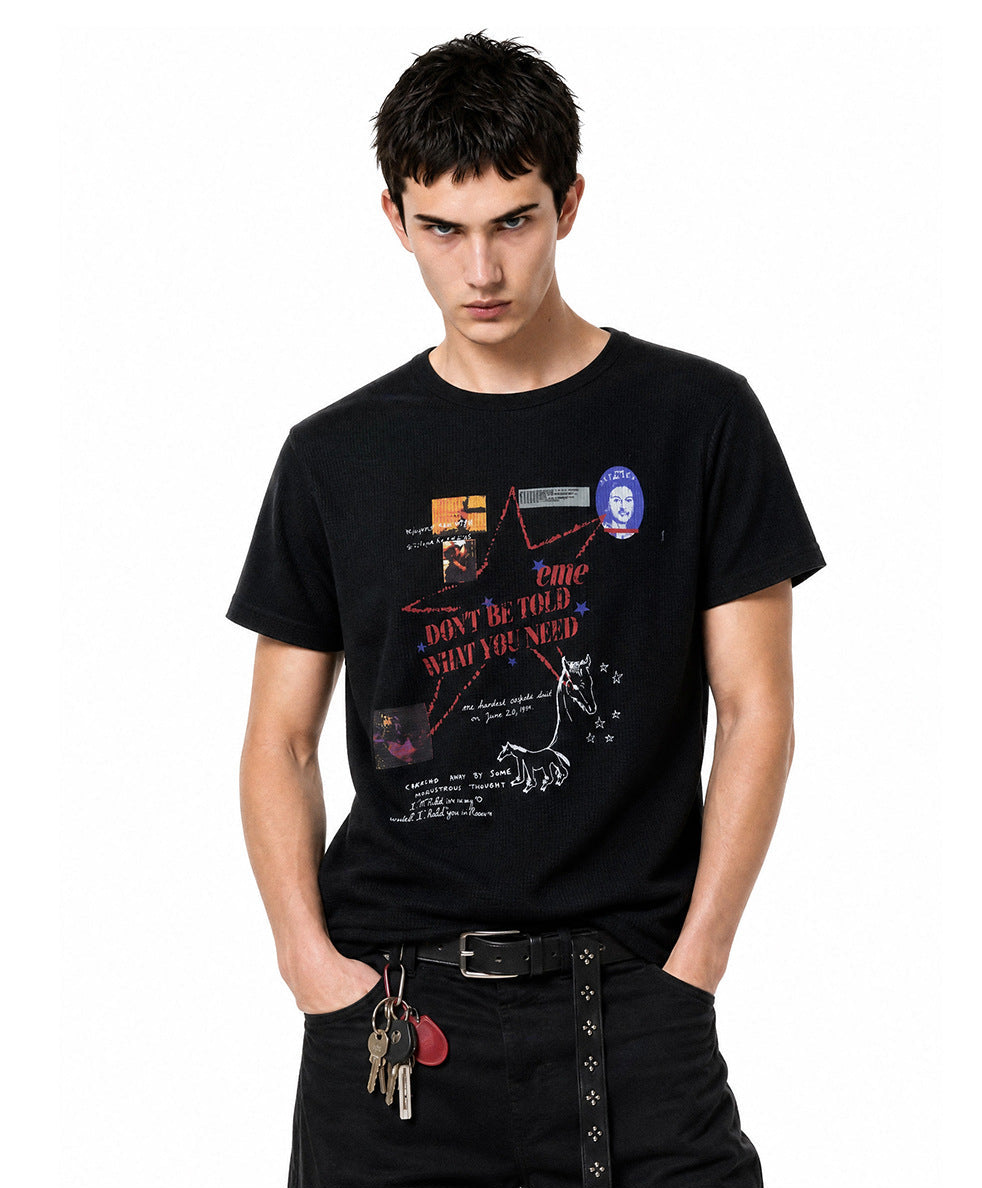 Medium shot of model wearing a black short-sleeve waffle knit t-shirt with graphic print on chest.