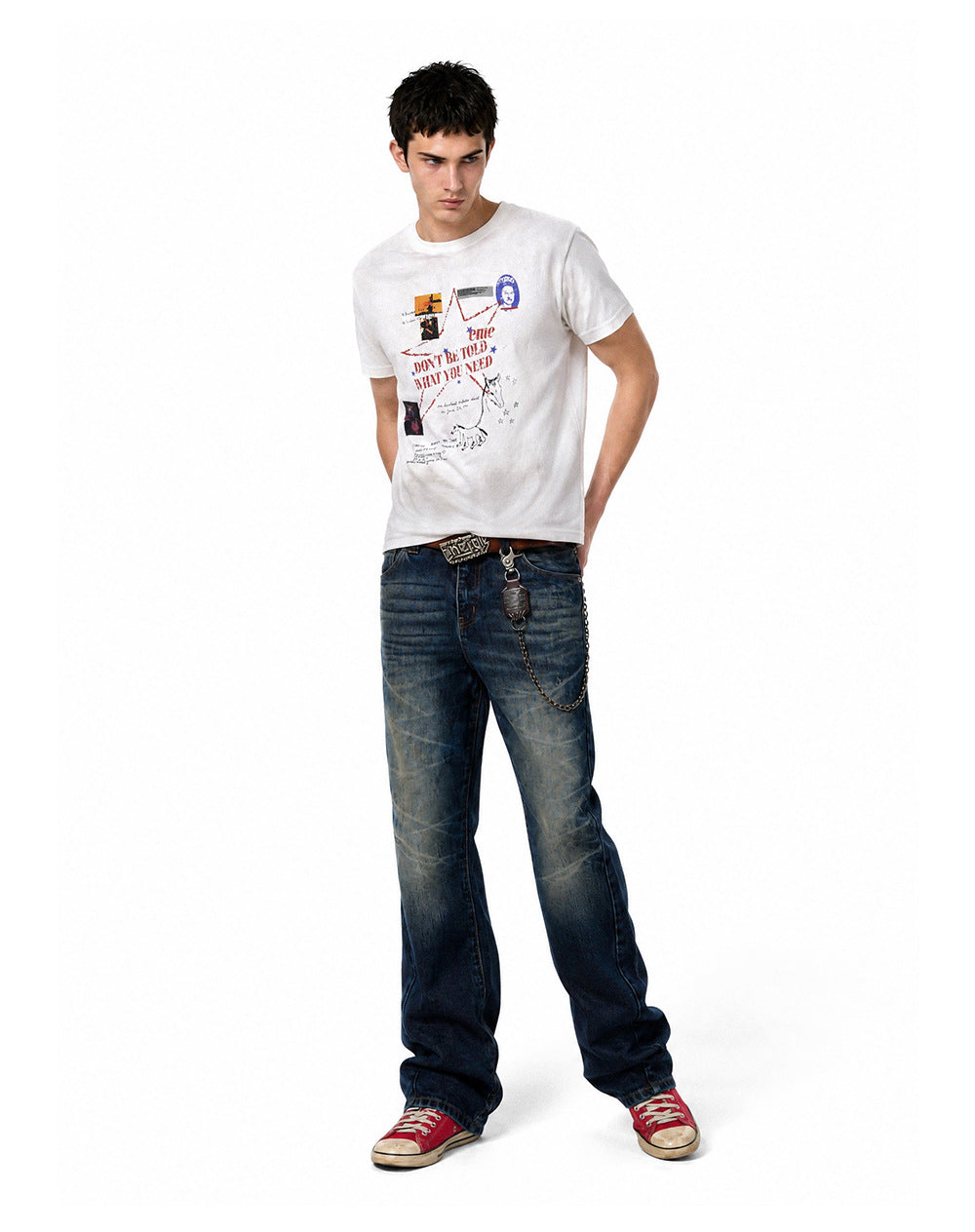 Full body shot of model wearing an off-white waffle knit graphic t-shirt with relaxed blue denim.
