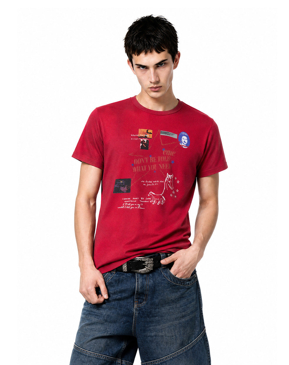 Medium front view of model wearing a red short-sleeve waffle knit graphic tee with blue jeans.