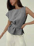 Minimalist belted sleeveless blouse styled with ivory trousers