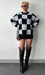 mock neck checkered sweater styled with black boots in minimal studio