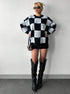 mock neck checkered sweater styled with black boots in minimal studio