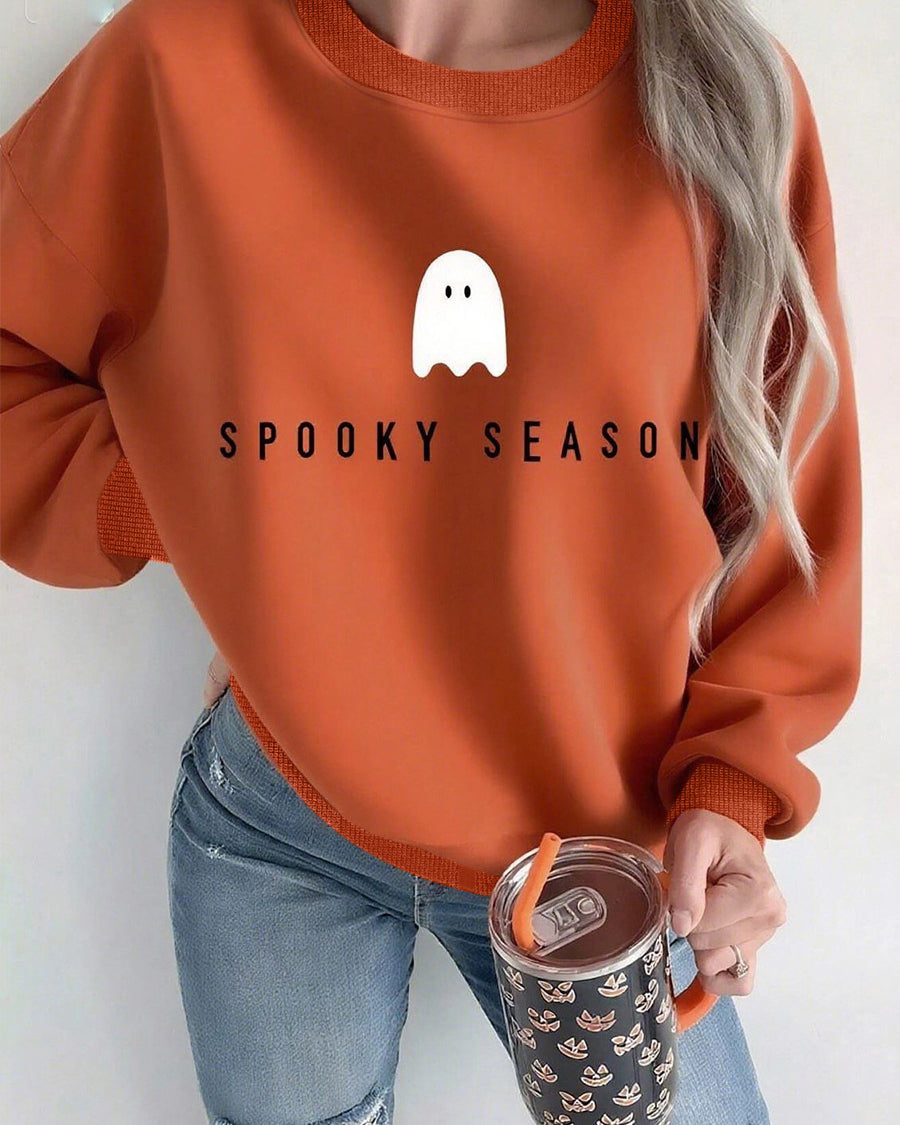 Mock neck oversized sweatshirt in terracotta with ghost “Spooky Season” print, front on model