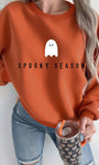 Mock neck oversized sweatshirt in terracotta with ghost “Spooky Season” print, front on model