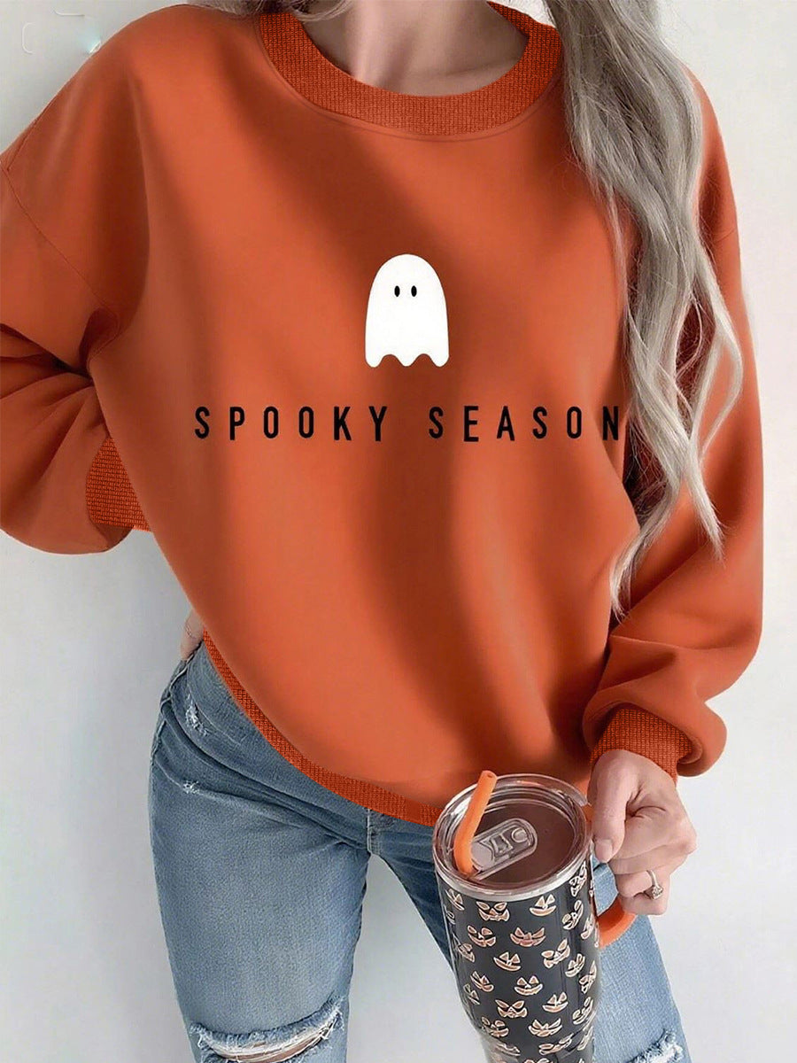 Mock neck oversized sweatshirt in terracotta with ghost “Spooky Season” print, front on model