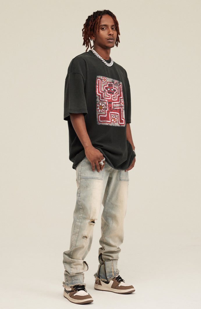 Model in black variant of tee with front skeleton and flower design.