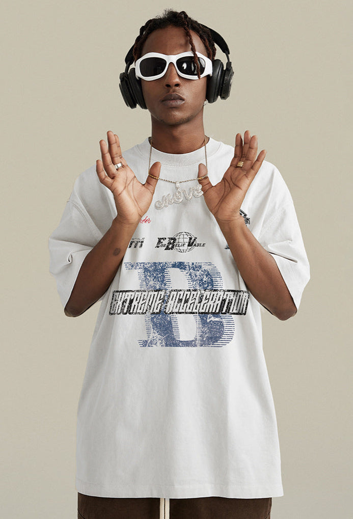 Model in white tee raises hands while wearing bold street accessories.
