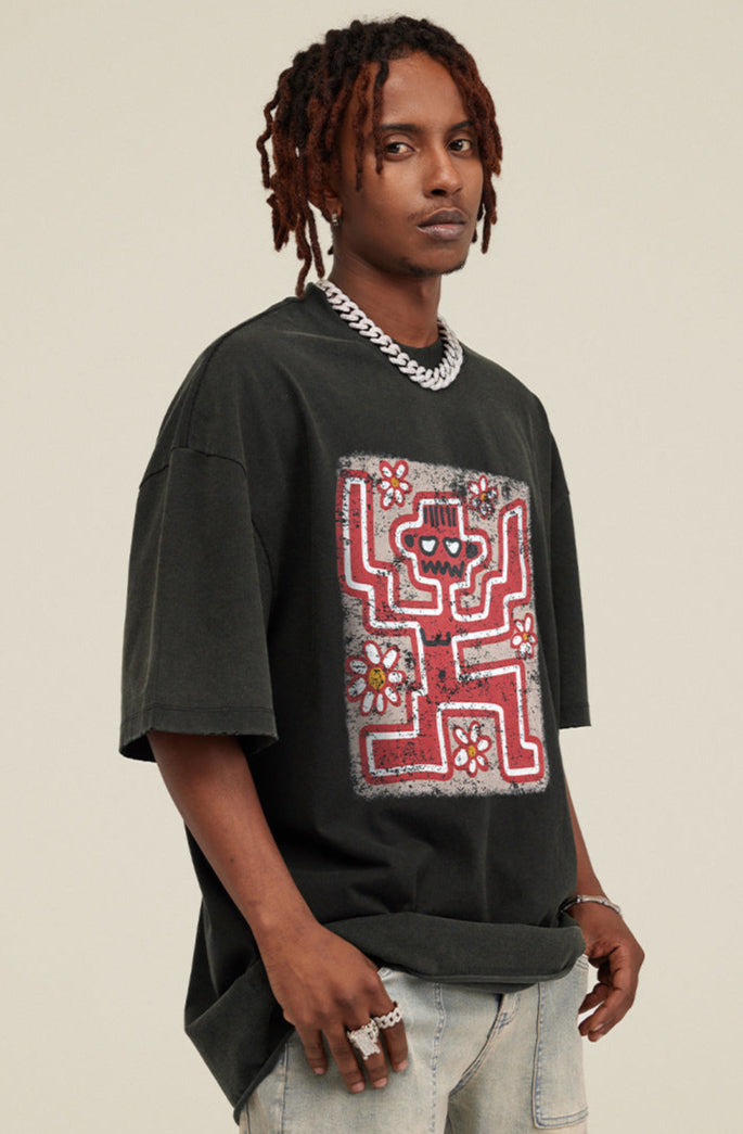 Model wearing rust black oversized tee with red skeleton and daisy graphic.