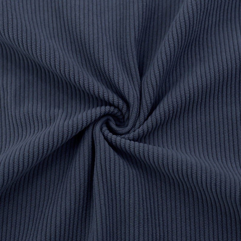 Close-up of navy blue ribbed fabric with a swirl pattern