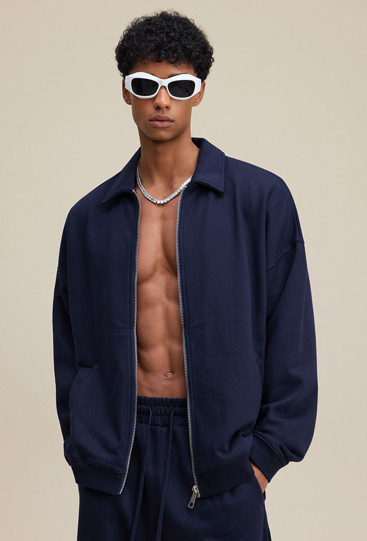 Navy polo zip up, three-quarter pose, loose fit