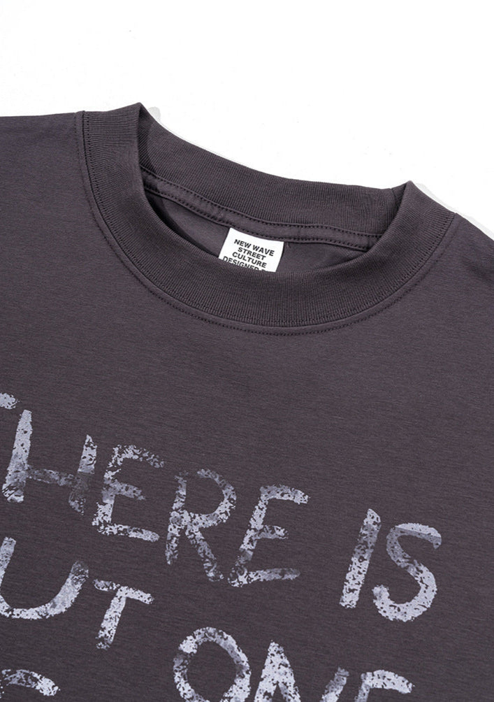 Close-up neckline view of dark purple 'Never Give Up' tee