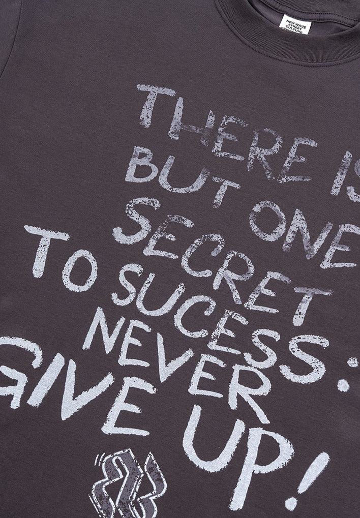 Flat lay of dark purple tee showing full graphic text