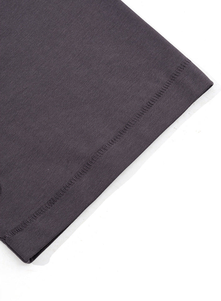 Hem detail of dark purple 'Never Give Up' tee