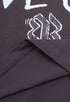 Inner stitching and logo print of dark purple tee, close-up view
