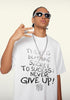Model in white tee doing street-style hand gesture, graphic quote visible