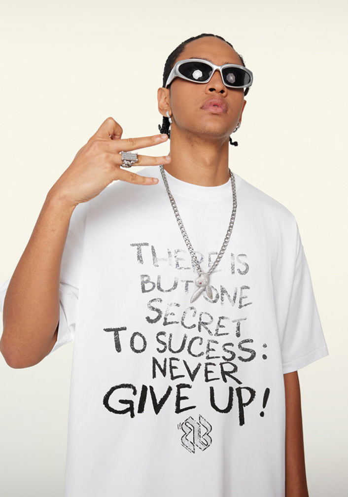 Model in white tee doing street-style hand gesture, graphic quote visible