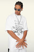 Model posing with arms crossed in white 'Never Give Up' tee