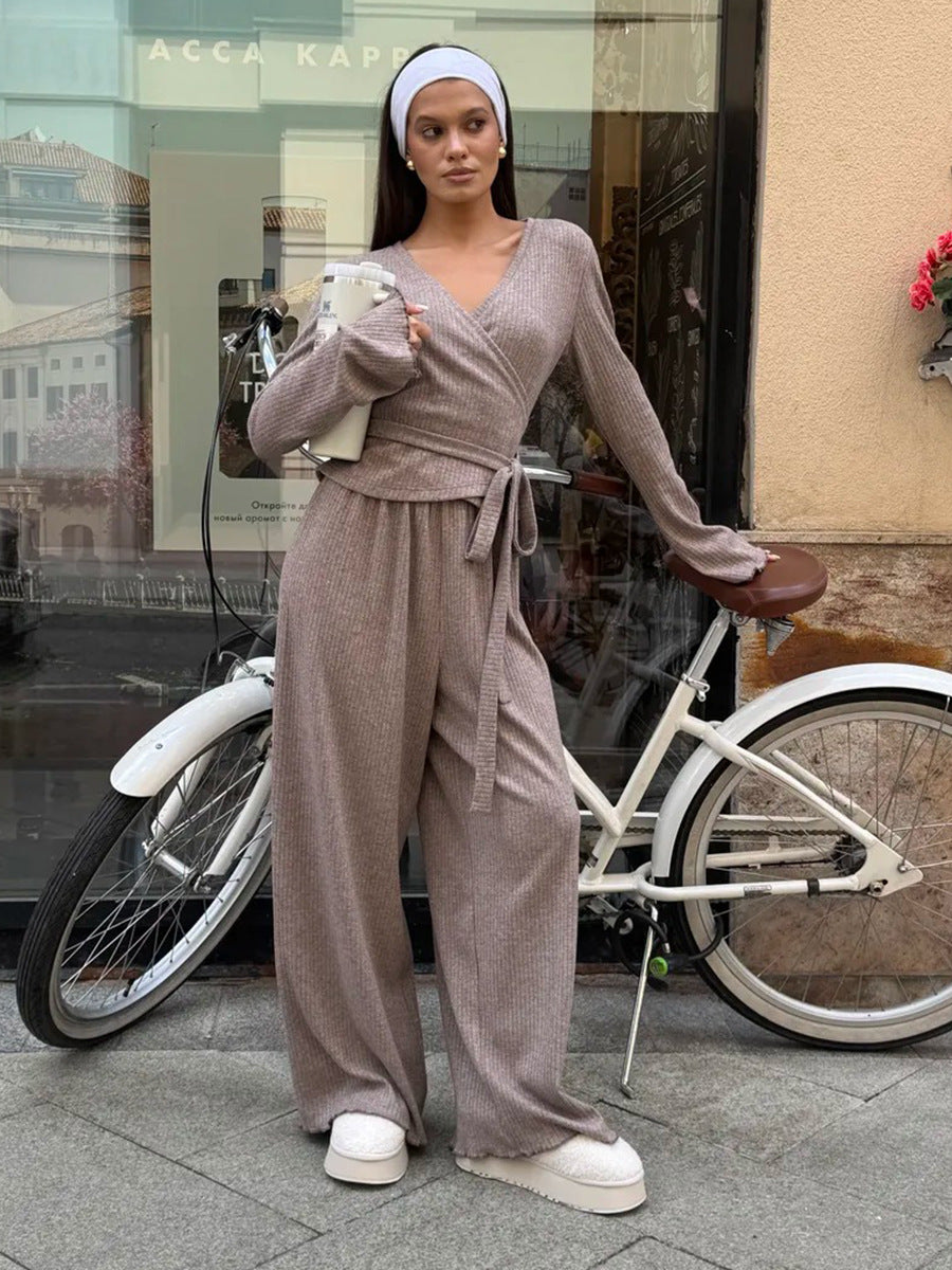 woman wearing oatmeal ribbed lounge set with white headband standing near shop window