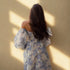 Back view of woman in off-shoulder puff sleeve floral gown 