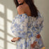 Angled view of woman in off-shoulder puff sleeve floral gown