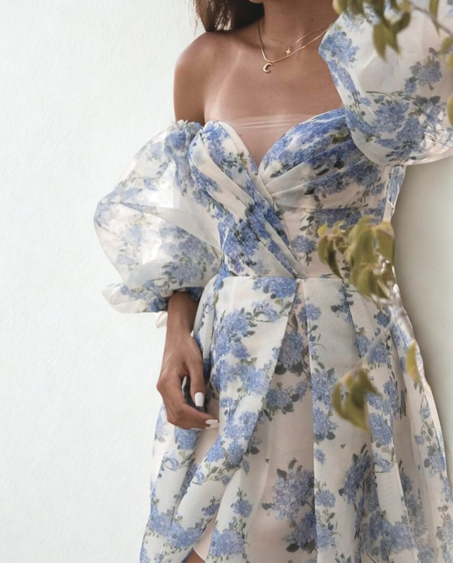 Woman wearing a blue and white floral gown.