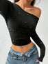 asymmetric off-the-shoulder top, black ribbed knit, cropped, hands on waist three-quarter view