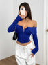 blue off shoulder top, long sleeve zip-front corset crop, front view with white pants