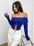 blue off shoulder top, long sleeve zip-front corset crop, side view with white pants